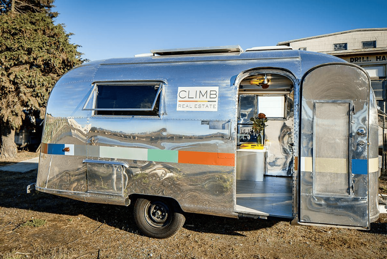 silver Airstream trailer sign by CLIMB Real Estate