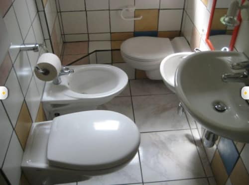 a bathroom with an unusual number of toilets in it