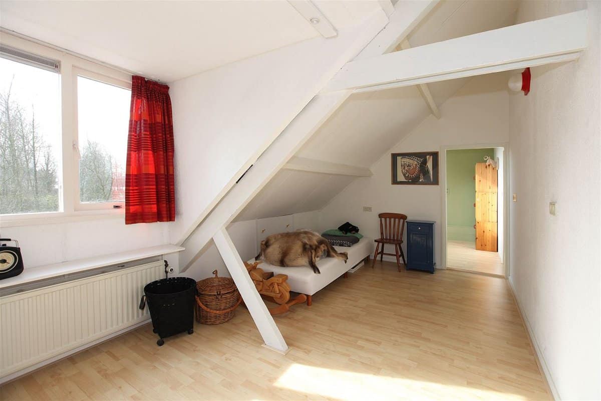 a bedroom with an unknown blur that looks like a dog on the bed