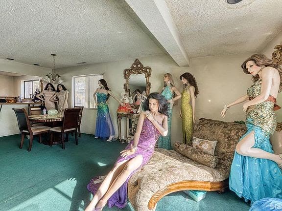 a living room garish carpet filled with very bizarre mannequins in evening dresses