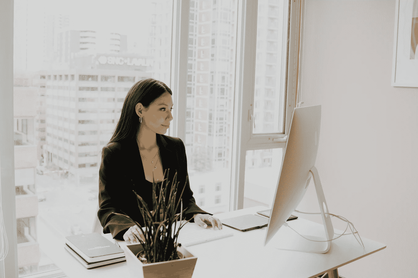 a woman working on her office with a good view