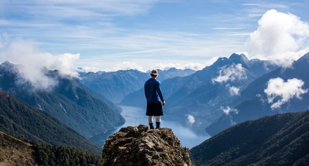 Man Standing on Top of the Mountain