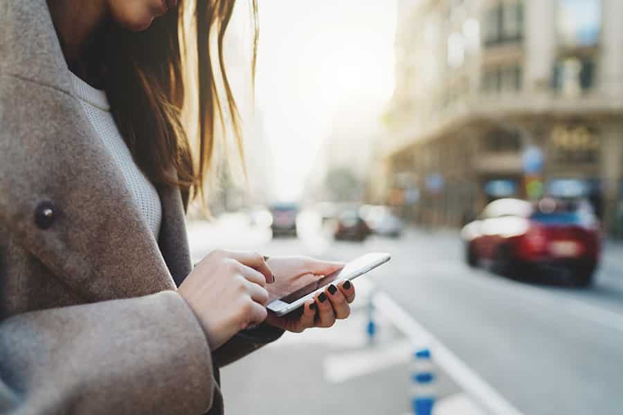 Close up photo of a woman using her smart phone