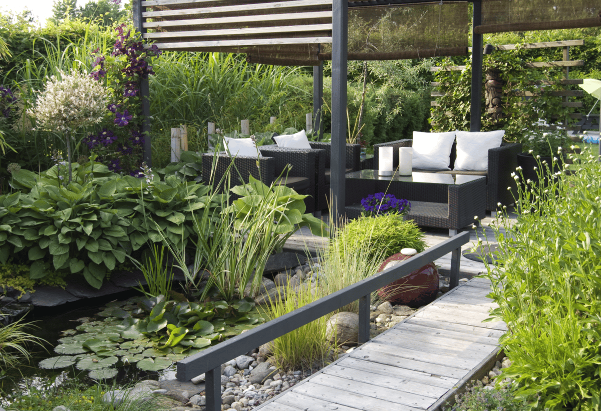  A backyard patio surrounded by well-manicured greenery