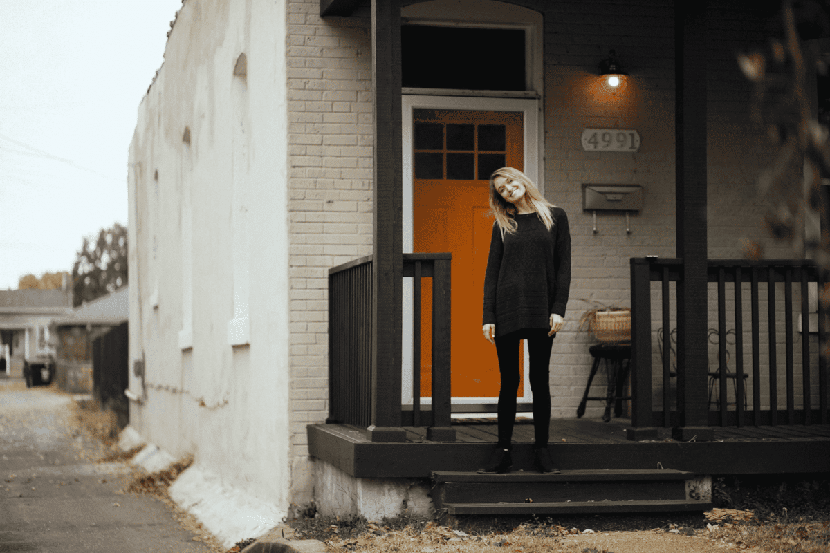 smiling in the front of the house