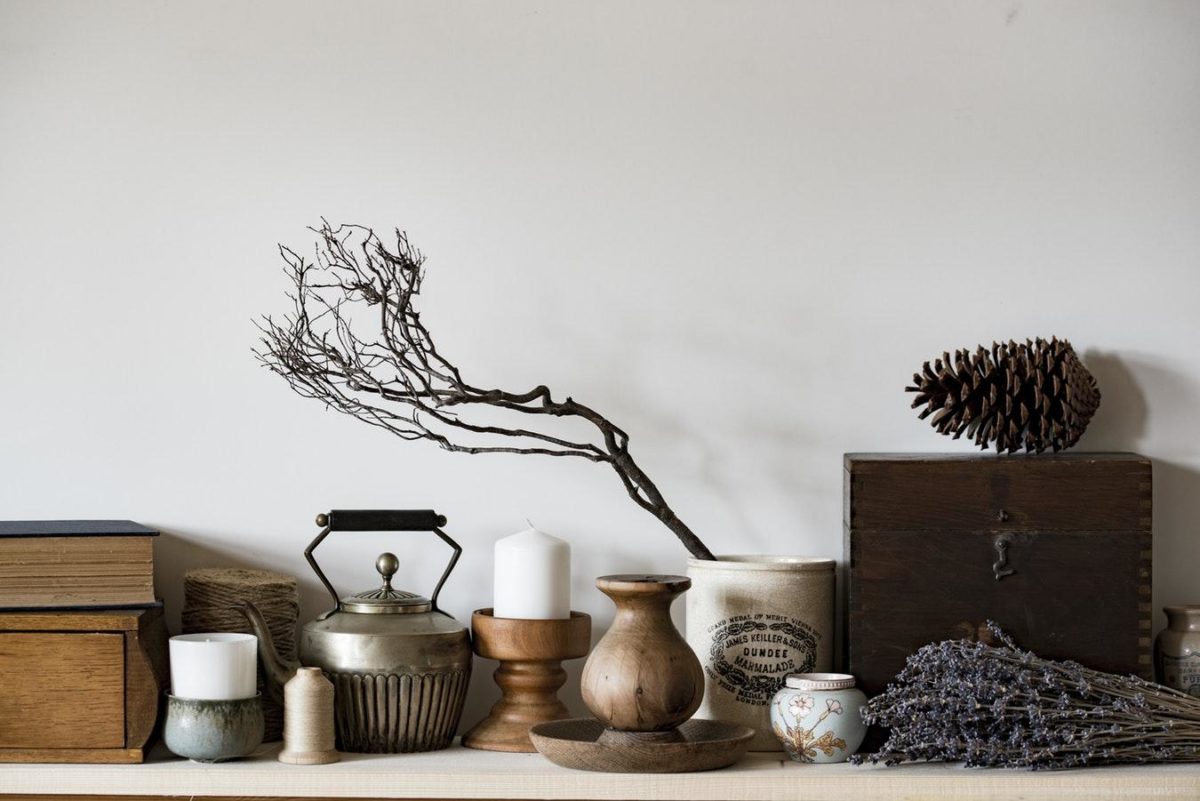 Several curio pieces including wooden boxes, a tea kettle, and candle holders on a shelf