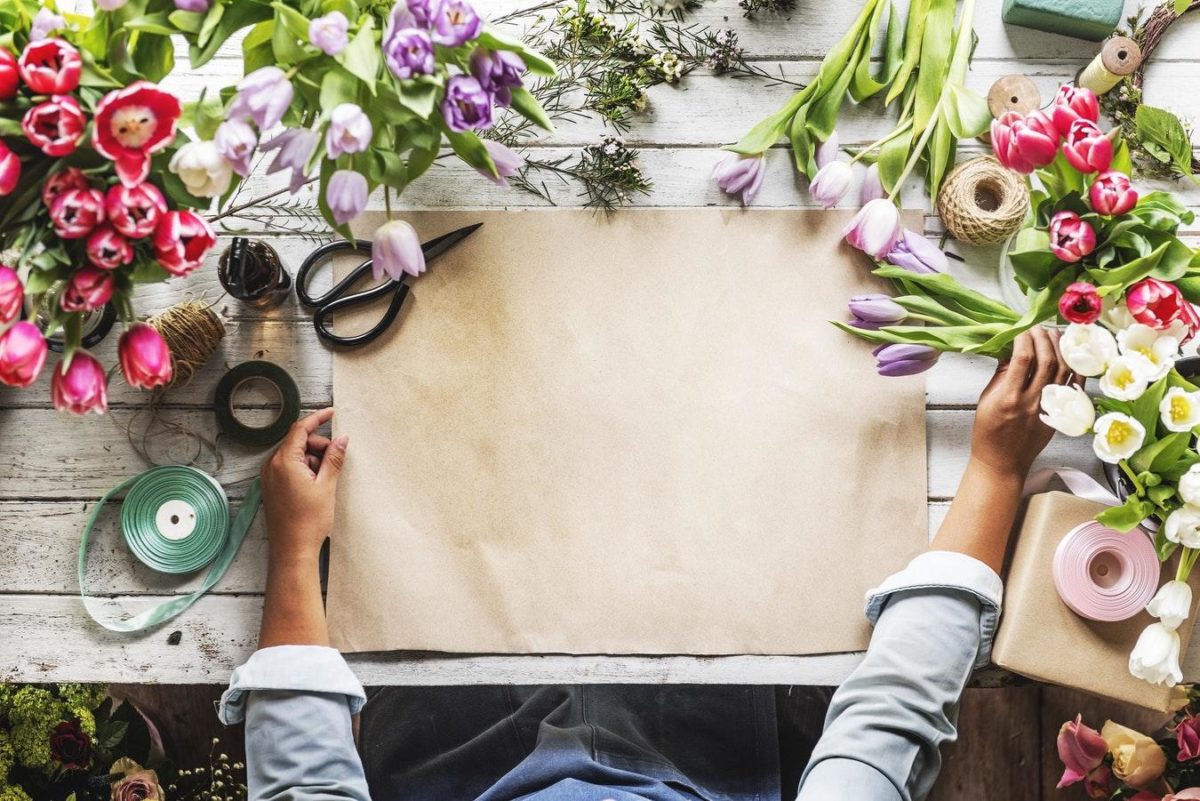 Florist wrapping flowers in brown paper