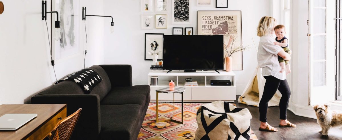 Woman holding her baby in a nicely decorated living room