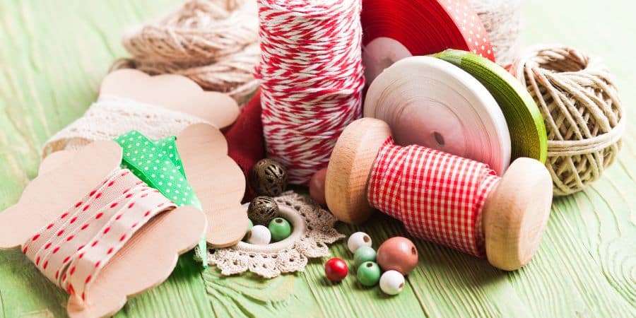 table with Bobbin, wooden beads, ribbon, organic yarn and patches