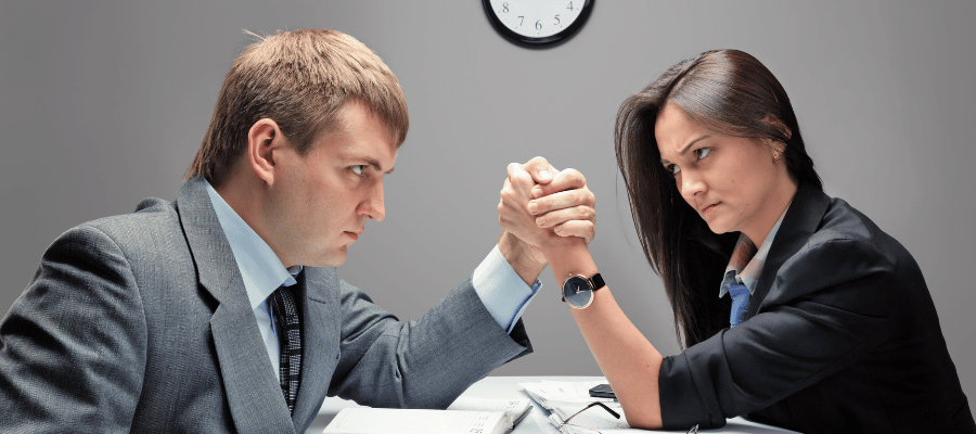 business man and woman arm wrestling