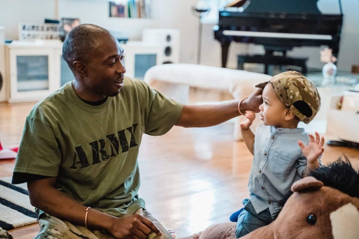 A Army visiting his child and giving a hat