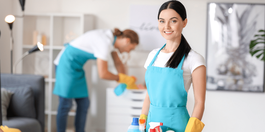 Two people cleaning a house