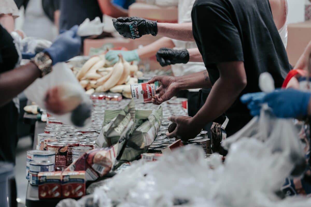 volunteers put together bagged lunches at a soup kitchen