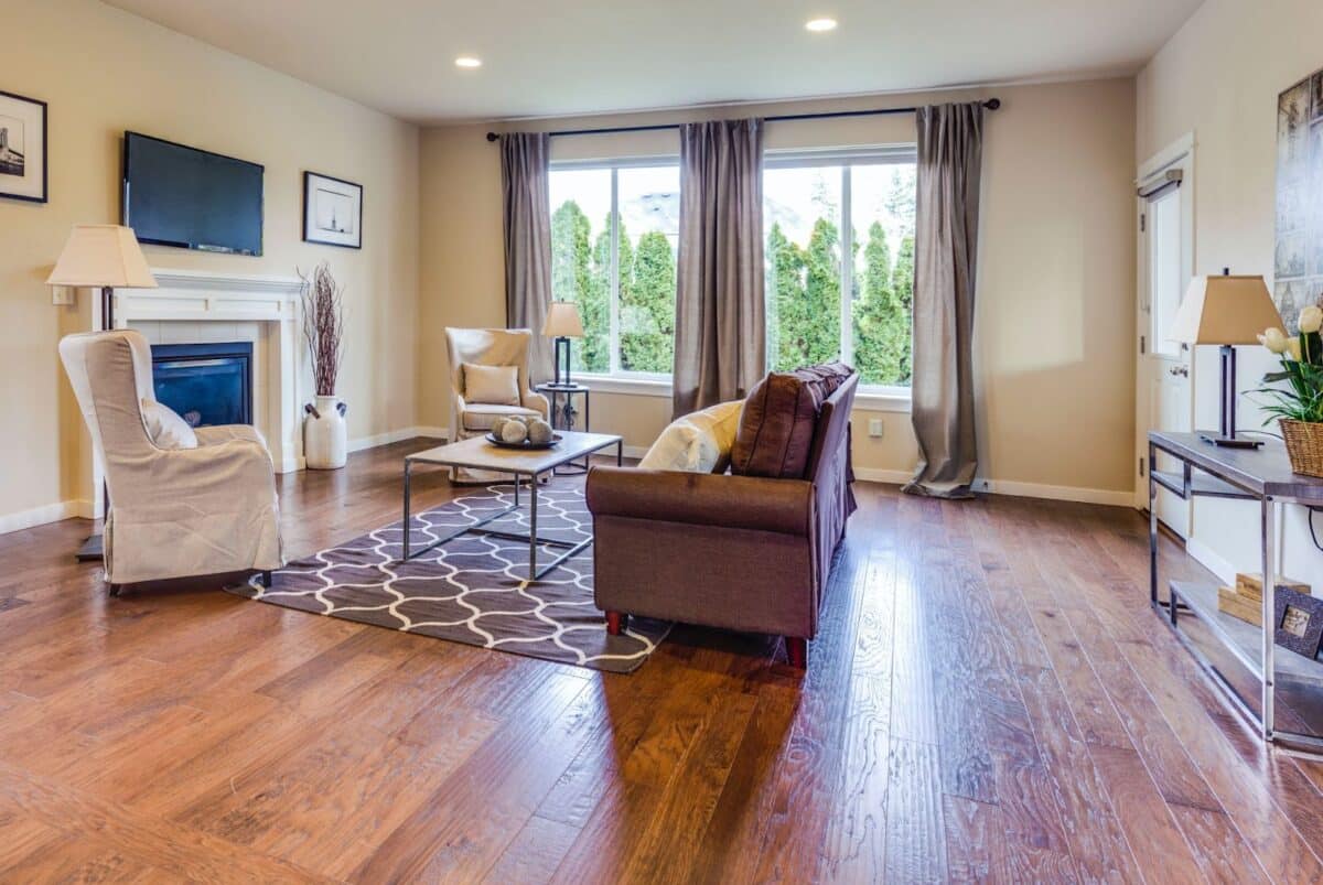 Drapes that hang from the ceiling to the floor make this living room look larger.