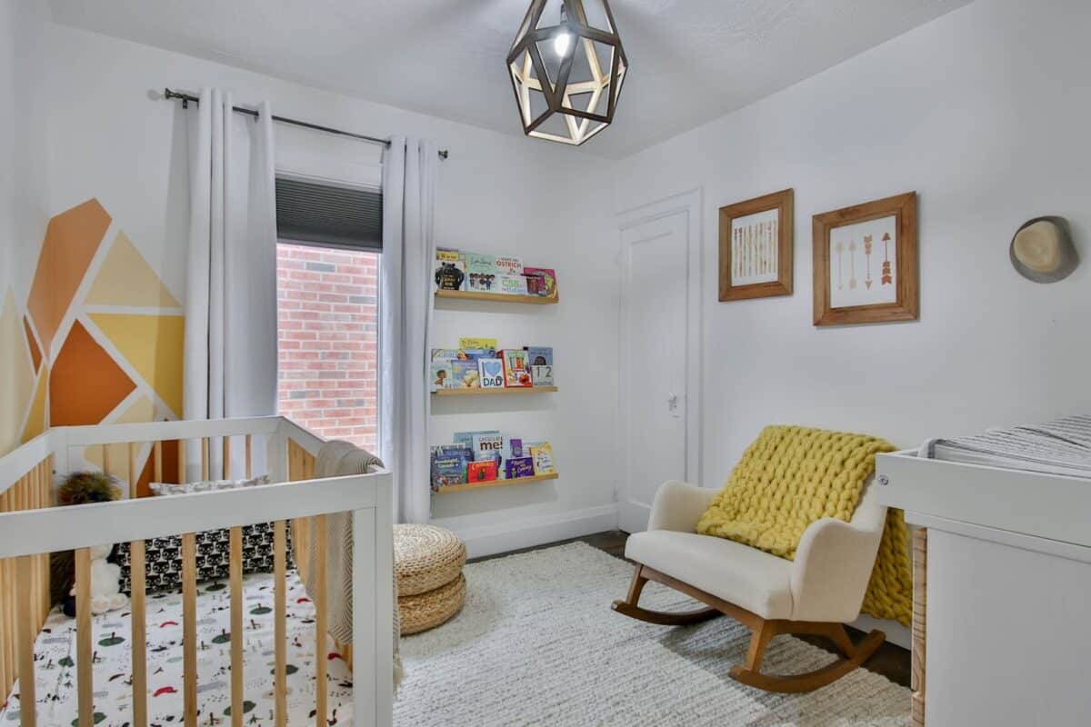 Use gender neutral colors when staging a child's room, like these warm cream, beige, and orange tones