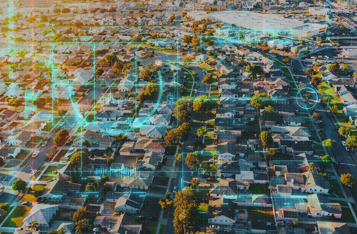 Neighborhood laid out on a grid with technological screen overlay with circles and data about certain homes.