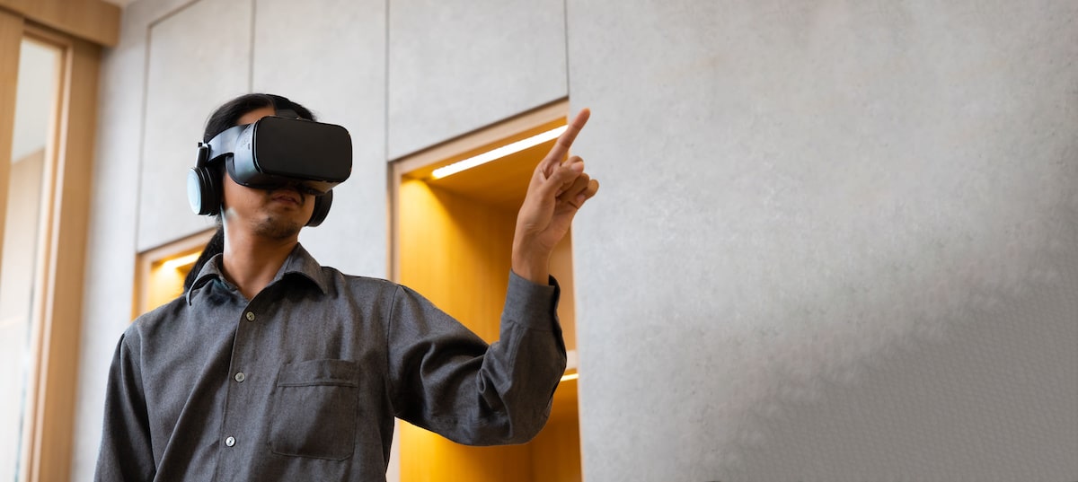 man with vr headset playing in a living room