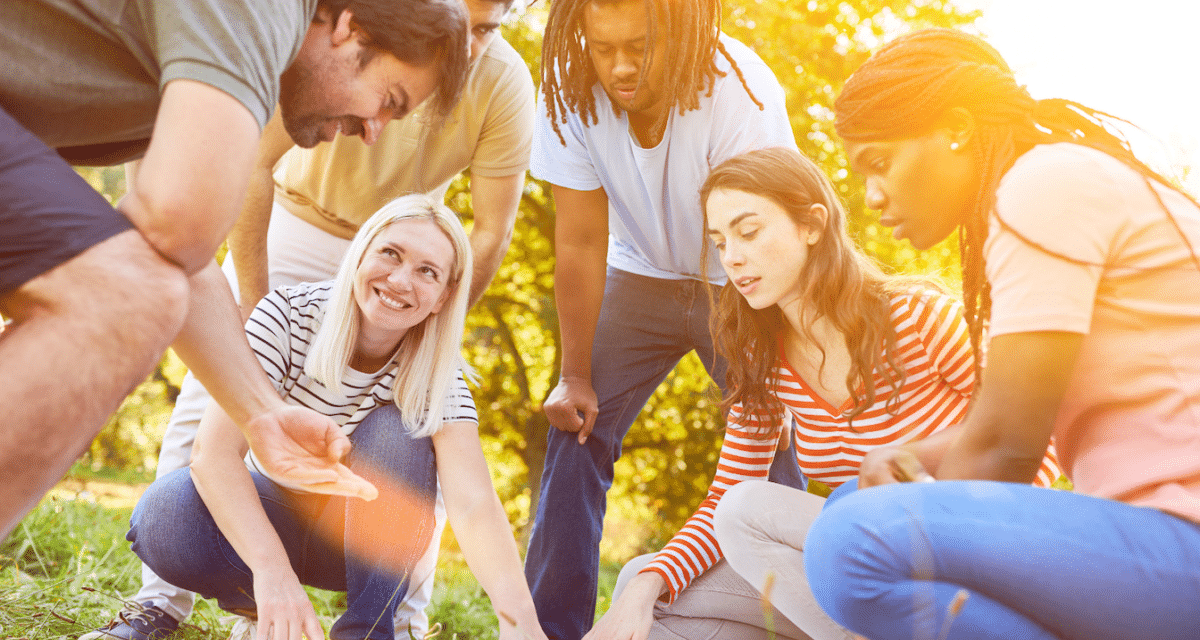 Image of a group of people in a circle planning their strategy for a scavenger hunt.