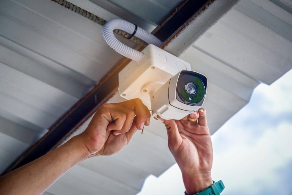 Technician installing a security camera